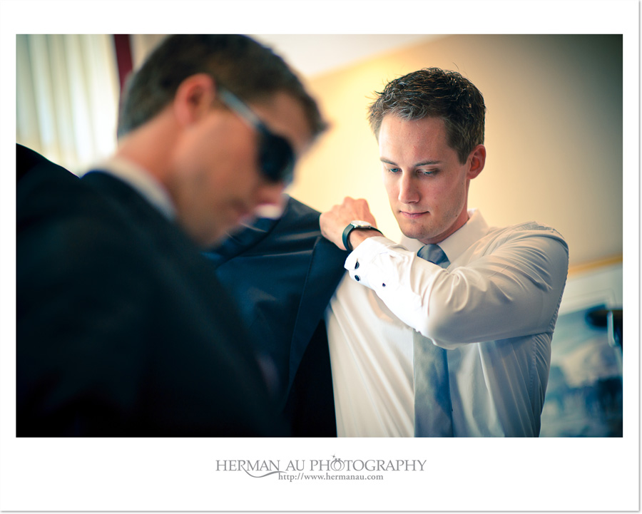 groom putting on jacket photojournalism capture