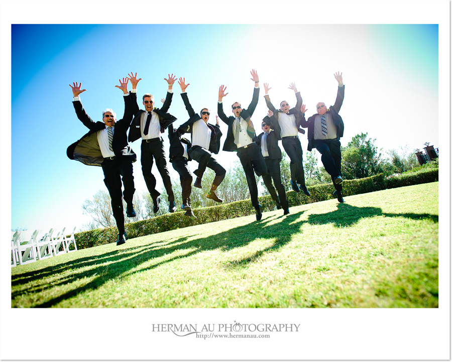 contemporary groomsmen and fathers jumping portrait