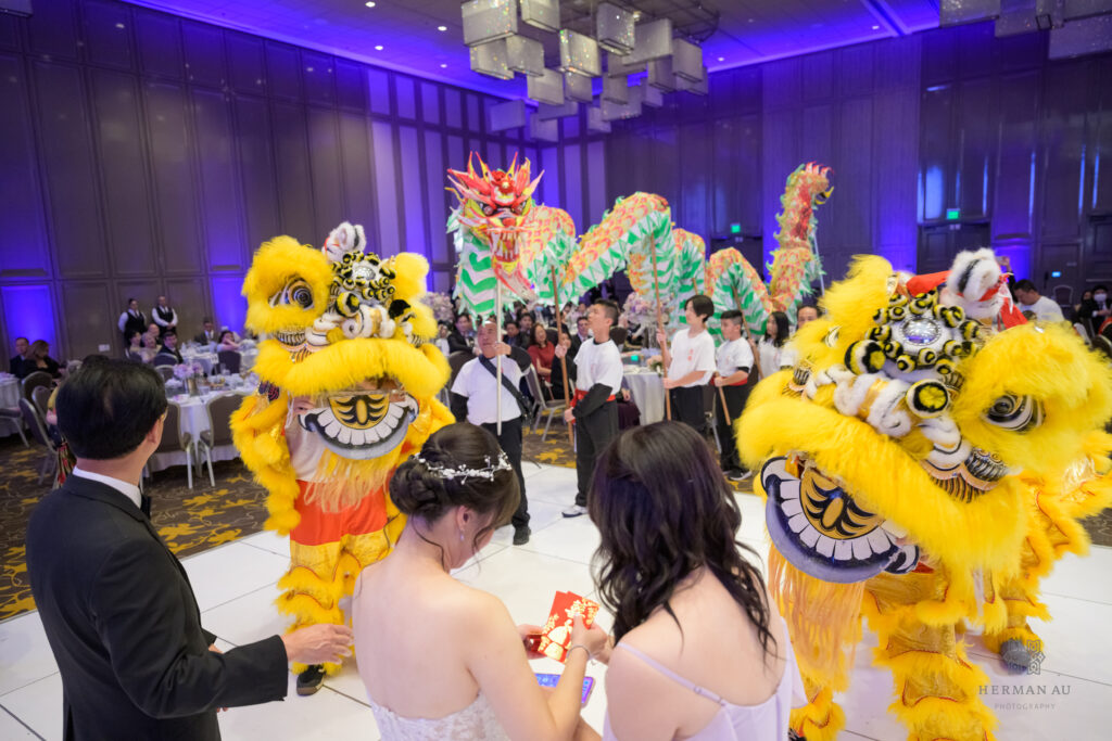 traditional lion dancing performance in a Chinese wedding celebration featuring 2 lions and a dragon